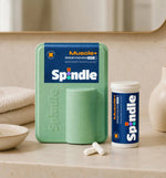 Spindle muscle+ supplement packaging on a bathroom counter with Muscle+ Akkermansia product.