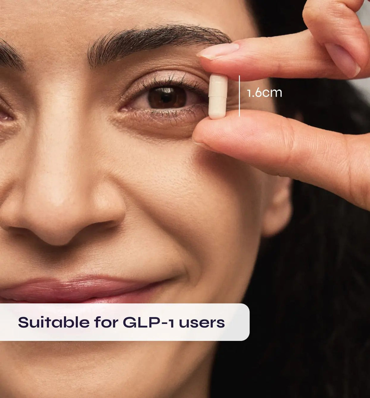 Close-up of a person's eye with a finger pointing to the iris, showing a measurement of 1.6cm, suitable for GLP-1 users.