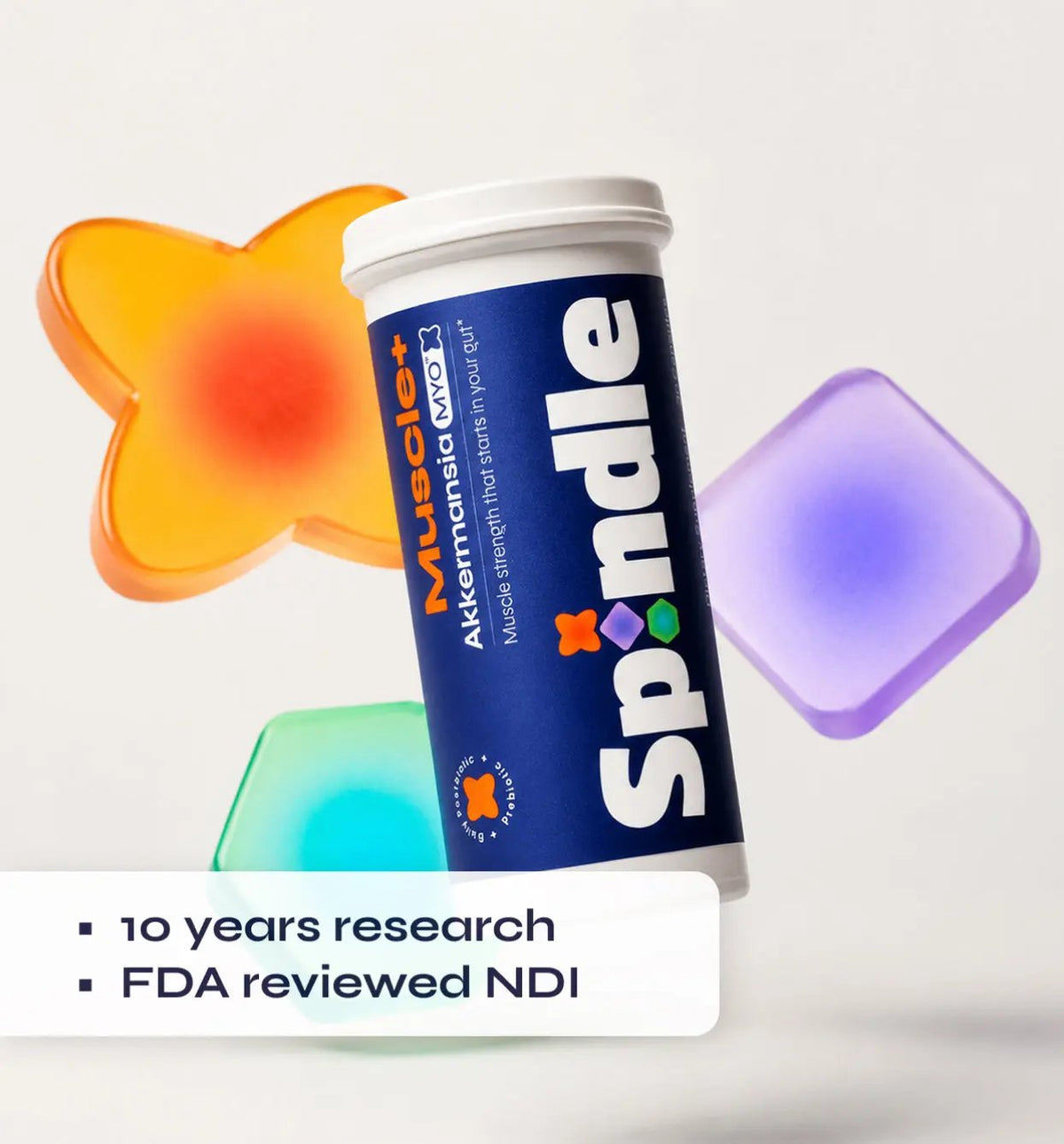 Spindle supplement container with colorful gel-like objects on a white background