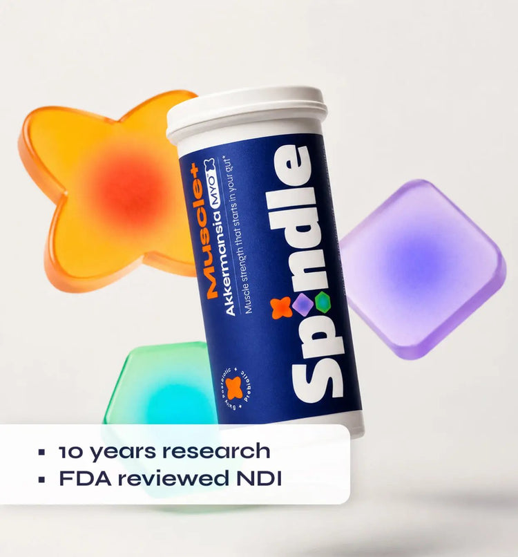 Spindle supplement container with colorful gel-like objects on a white background
